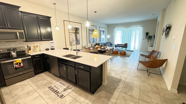 Spacious open-plan kitchen with modern appliances and seating for six.