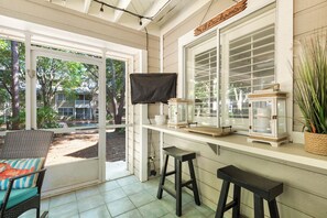 Screened in patio with flat screen and eat-in bar seating