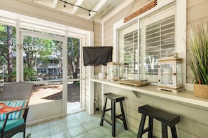 Screened in patio with flat screen and eat-in bar seating