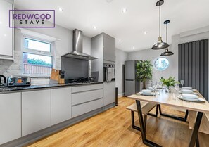 FULLY EQUIPPED KITCHEN AND DINING TABLE