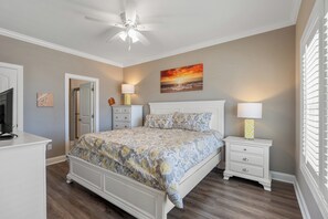 Relax in this primary bedroom after a fun day in the sun.