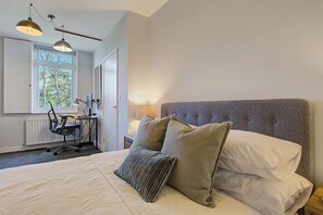 Double bed, with fresh white linens and sumptuous  pillows