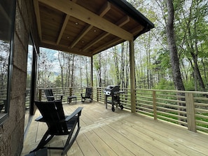 Porch with a view of the mountains through the trees.