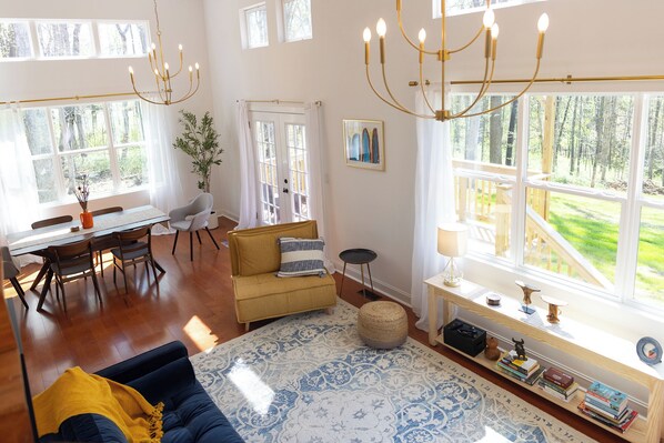 Two story open living and dining room with plenty of natural light