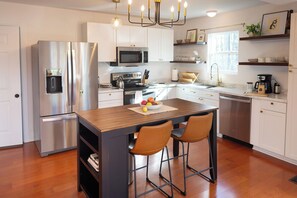 Kitchen is fully stocked with dishes, bakeware, pots, pans, wine glasses...