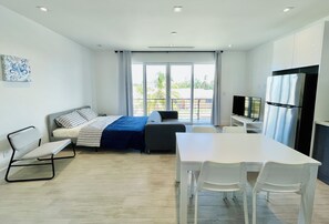 Bedroom space with living space, kitchen and dining.