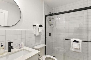 Bathroom featuring a single vanity, and a luxurious stand-in shower. Towels, toiletries and a hair dryer provided.