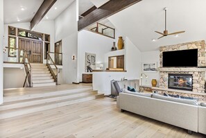 Spacious Living Area With Staircase and Loft.