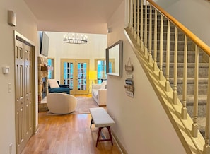 Front Entry Foyer with stairs to Upper Level. The Foyer opens onto the Great Room, Dining Area and Kitchen.