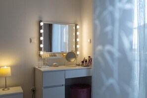 Bathroom 1. with king bed, shower, makeup table and exit to balcony.