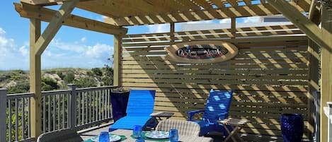 Oceanfront Gazebo with BBQ, lounge chairs and dining table.