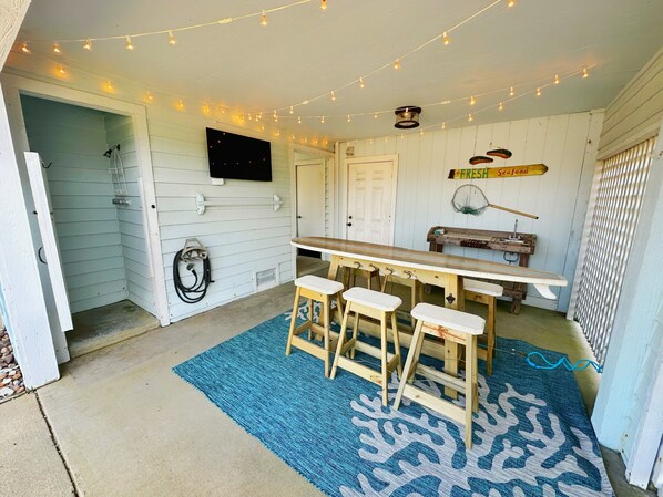 Outdoor dining area with tv