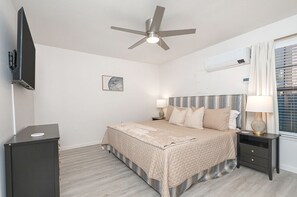 Large bedroom featuring a king-size bed and a 55-inch TV.