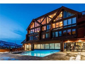 Outdoor, heated pool at night.