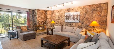 Open floor plan living room with mountain and lake views