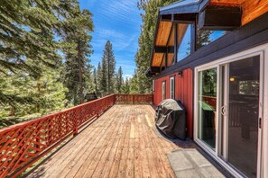 A spacious deck is the perfect spot to enjoy the summer sun or take in the forested setting.