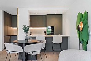 Indulge in culinary delights in our fully equipped kitchen that opens to a cozy dining nook.