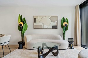 Lounge in luxury, surrounded by curated art and lush green accents.