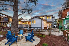Private Unit B fire pit area with 5 Adirondack chairs and fire pit.