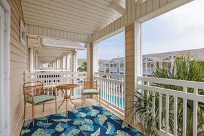 Take a breath of tranquility on the private balcony with pool view