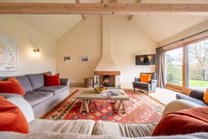 Raynham Breck, Tittleshall: Sitting room with wood-burning stove