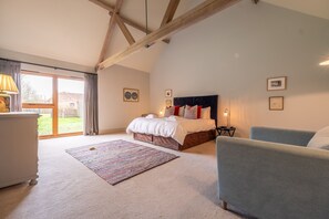 Raynham Breck, Tittleshall: Master bedroom with 6' super-king size zip and link bed with bespoke, upholstered headboard