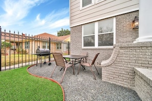 On site front patio, where a patio table and charcoal grill await. Prefer gas grilling? No worries, we've got you covered with an on-site option. It's your spot for outdoor grilling, promising a delightful stay from the moment you arrive.