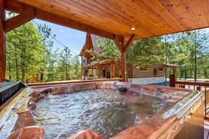 End your day with a soak in this inviting hot tub under the stars, nestled in serene woods.