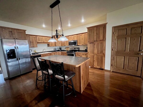 Spacious kitchen is fully stocked with pots, pans and small appliances. 