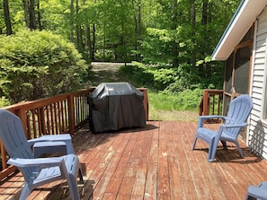 Deck with grill, screened porch to the far right.