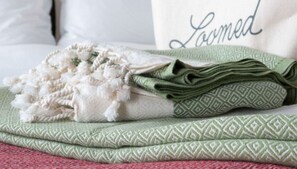 Close-up of inviting bed with 'Dream' pillow and stylish comfort layers