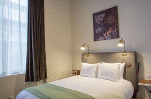 Calm sleeping space with fresh linens and serene lighting