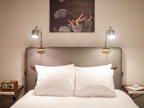 Cozy bedroom with soft lighting and artistic touches above the headboard