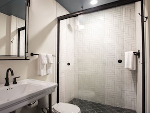 Contemporary bathroom featuring dual sinks and chic subway tile design