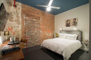 Bedroom blending exposed brick and modern lighting for an urban oasis