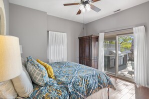 Cozy bedroom with direct access to an outdoor deck, perfect for morning coffee or evening barbecues with a lake view.
