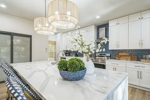 Gorgeous Chef's Kitchen with Huge Island! The kitchen island, dining, and living area providing comfort, providing a seamless flow for cooking, dining, and relaxation.