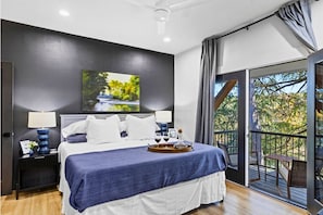 The master bedroom features a luxurious king bed, ensuring a comfortable and restful night's sleep, along with a smart TV for your entertainment.