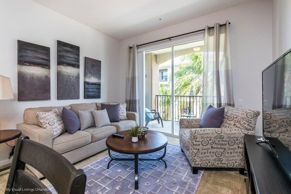 Captivating living area of the condo in Orlando Florida - Stylish furniture arrangement providing comfort and a cohesive look - Smart TV to watch your favorite show - Cozy seating area conducive to relaxation and socializing
