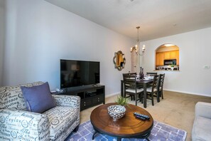 Calming living area of the condo in Orlando Florida - A living room that effortlessly combines sophistication, comfort, and functionality - Smart TV for entertainment - Thoughtful lighting design creates a warm and inviting ambiance