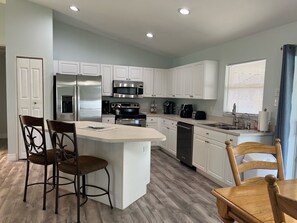 Well stocked kitchen with breakfast bar.  Newer Stainless Steel appliances.  