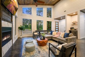 Open concept floor plan with windows surrounding the cabin