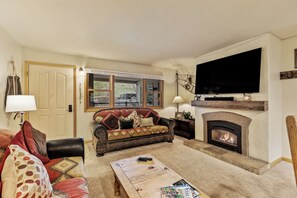 Comfy couches with fireplace and TV.