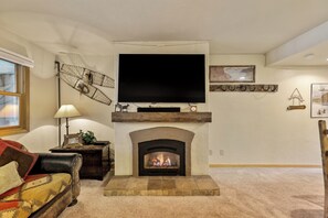 Flat screen TV and fireplace. 