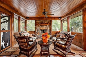 Screened porch on main level with wood-burning fireplace. 