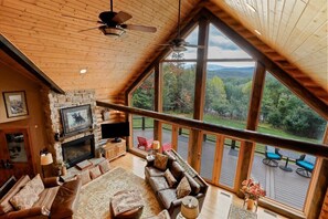 Open concept living room, gas fireplace, beautiful views, deck access.