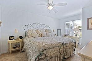 Plush and comfy king-size bed, desk space, and smart TV in the main bedroom.