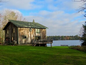 Enjoy the camp's screened gazebo,  lakeside seating, & flower and herb garden