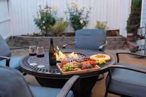 Fire table with string lights and detached Casita with bonus living room.