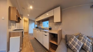 Kitchen area - fully equipped with kettle, toaster, fridge with small freezer compartment.  